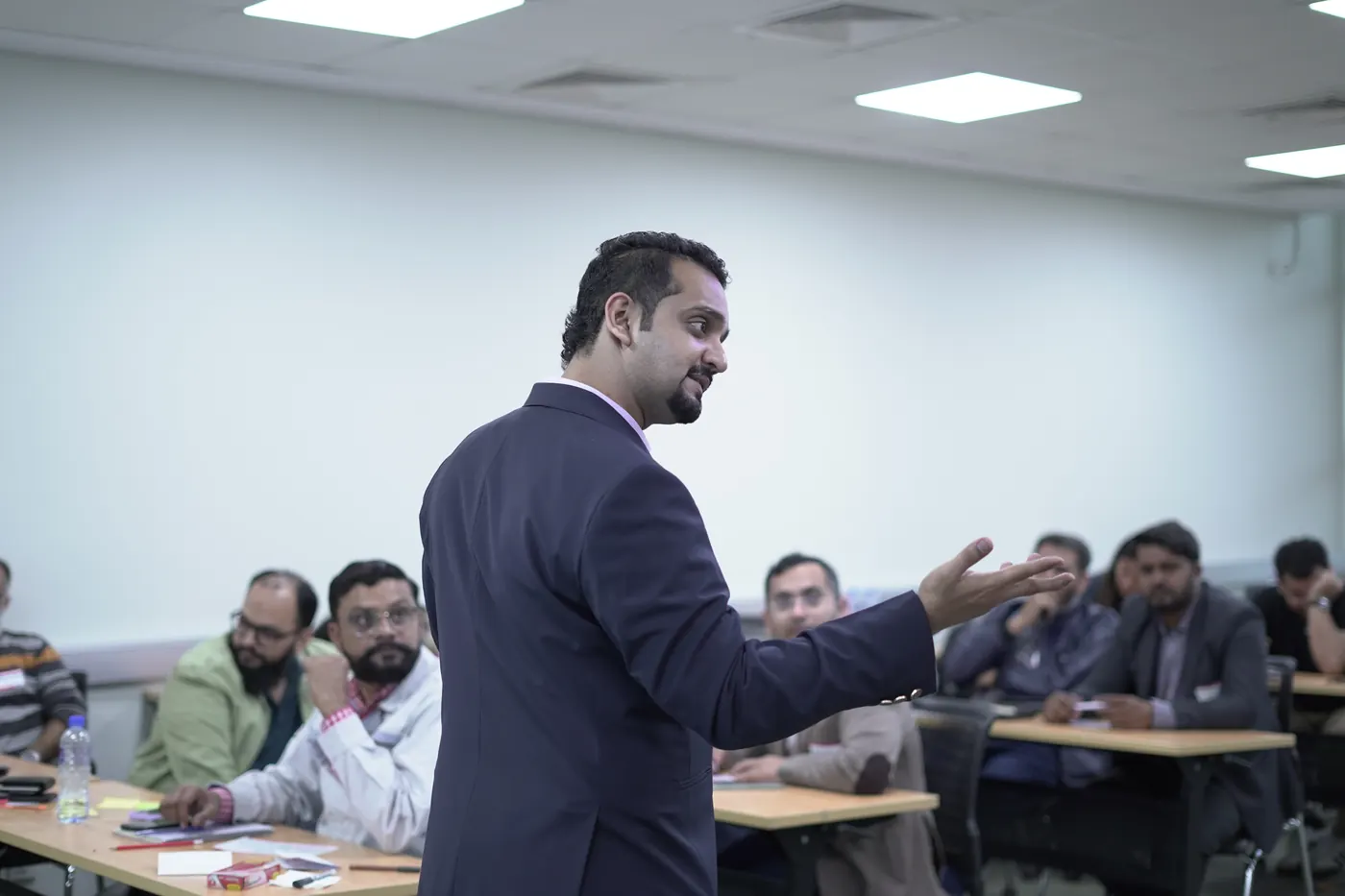 Facilitator leading a communication skills workshop with professionals