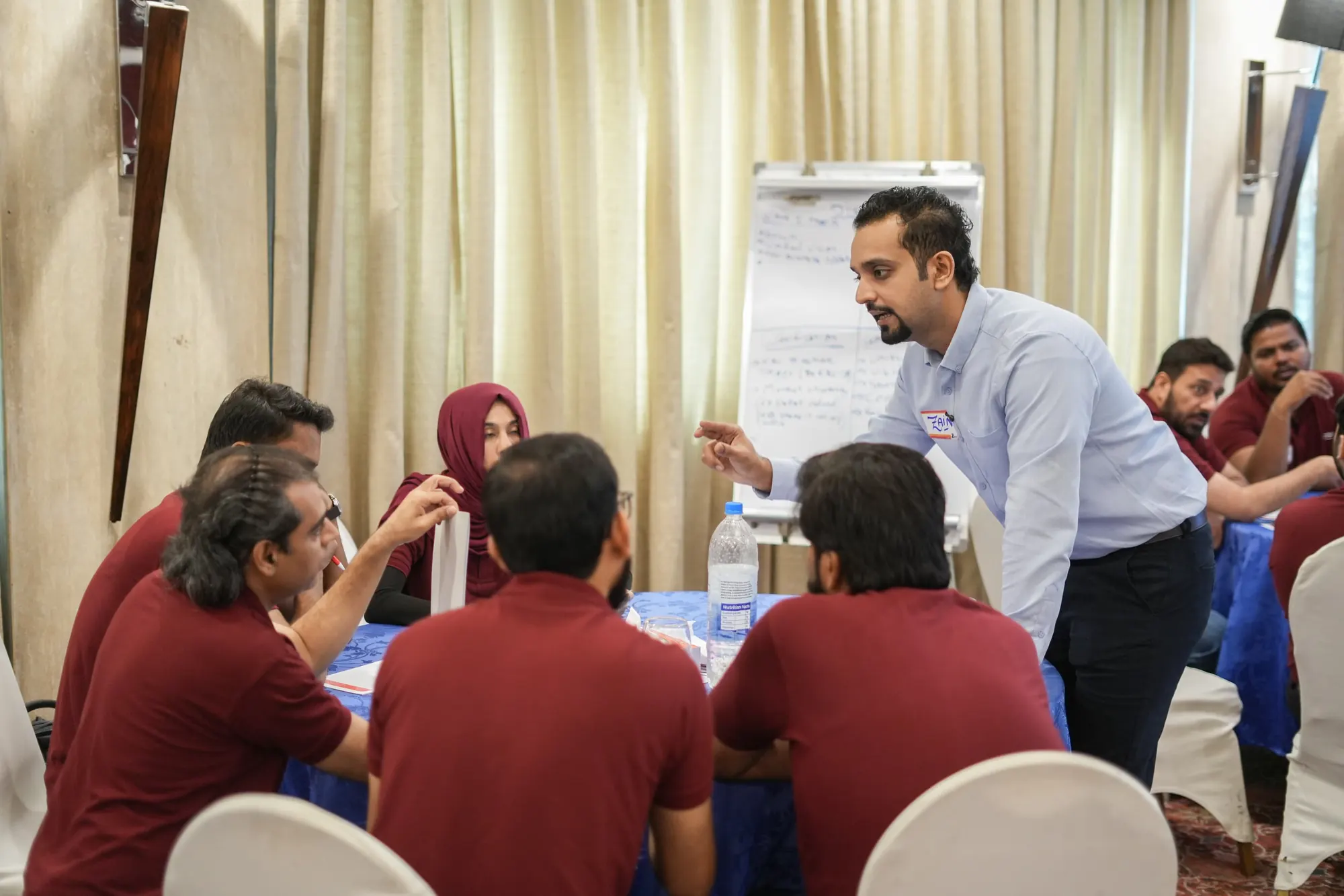 Zain Goplani working with a small group of leaders during a strategy retreat